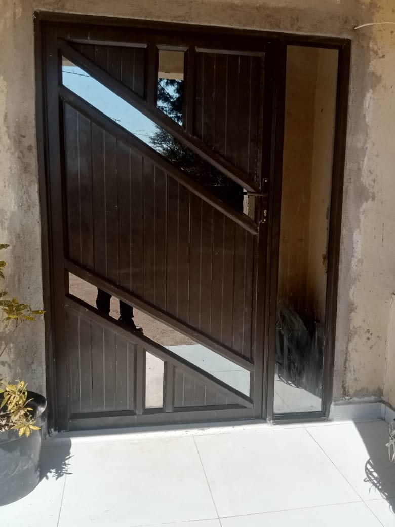Bronze aluminium Dutch-style door with diagonal glazing and matching sidelight — Tshipiworks