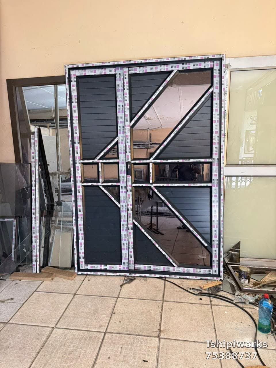 Geometric aluminium double door under fabrication in the Tshipiworks workshop