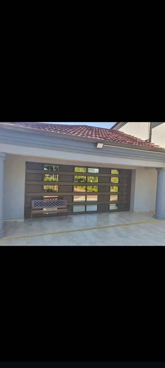 Custom dark aluminium full-view garage door at a Botswana home — Tshipiworks Gabane