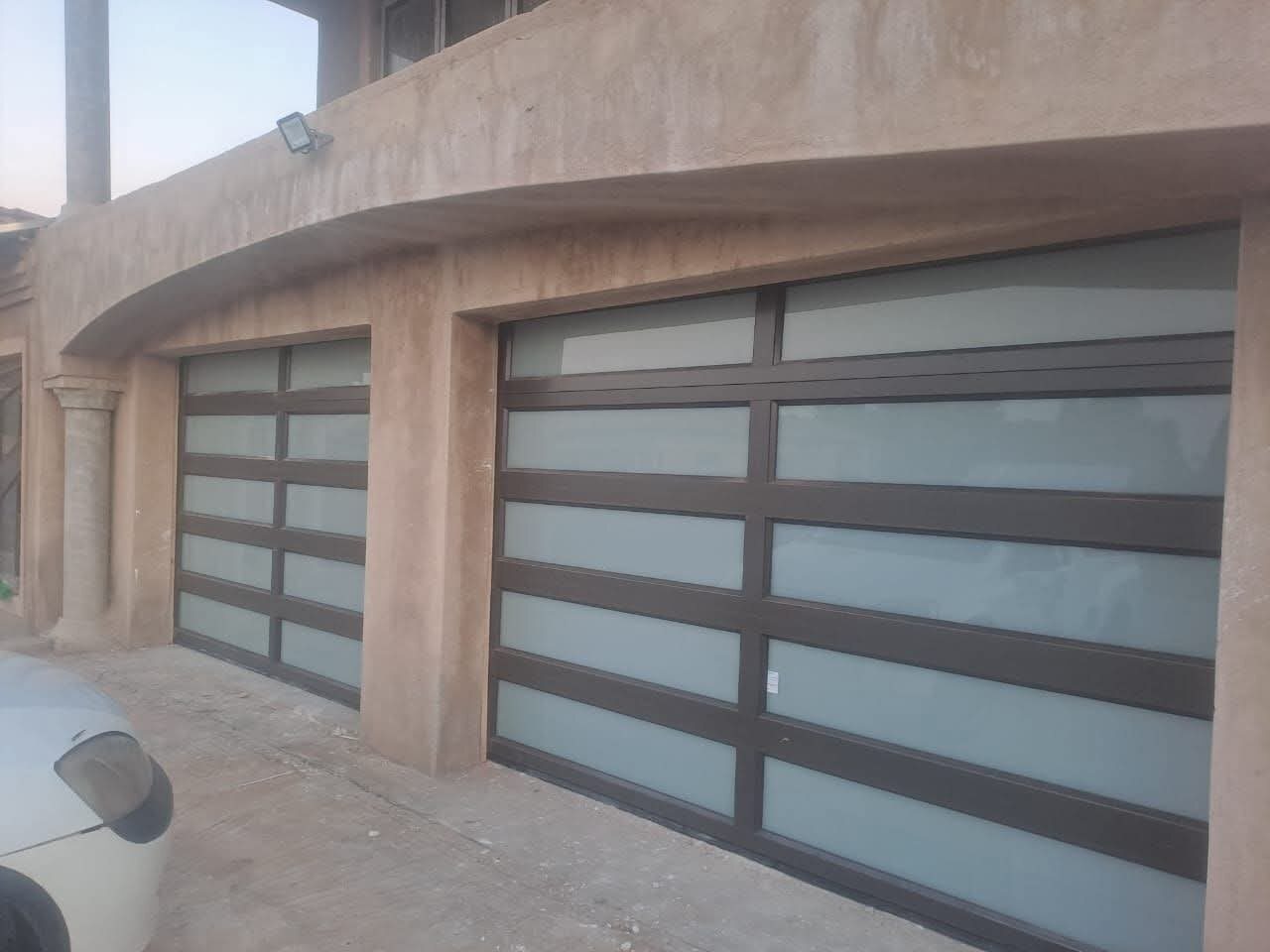 Double aluminium garage doors with full-view glass panels — Tshipiworks Gabane