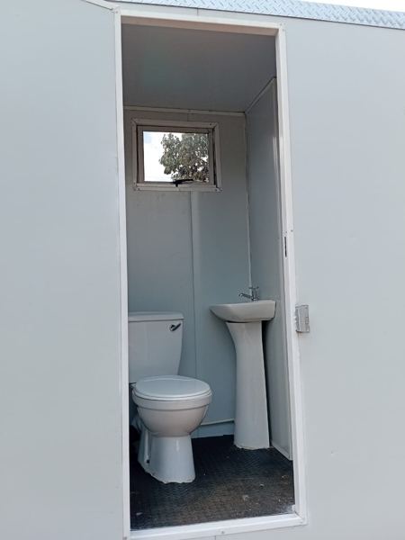 Second mobile toilet cubicle interior with basin and window — Tshipiworks