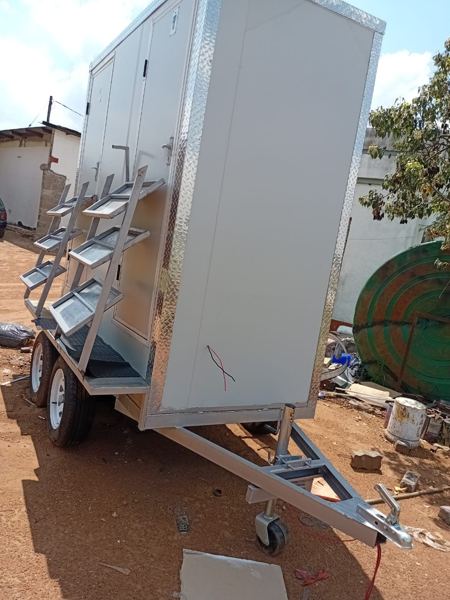 Mobile toilet trailer side view with steps folded for towing — Tshipiworks