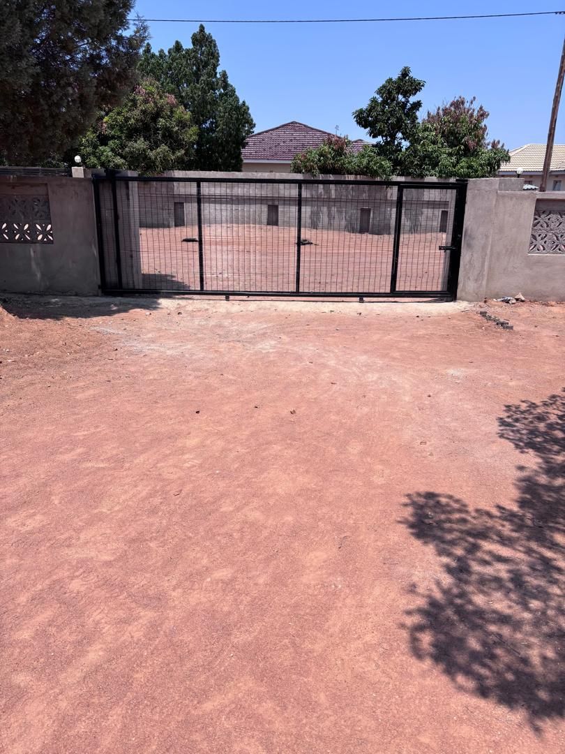Black ClearVu 358 anti-climb mesh sliding gate with integrated pedestrian gate, closed across a driveway in Metsimotlhabe — Tshipiworks