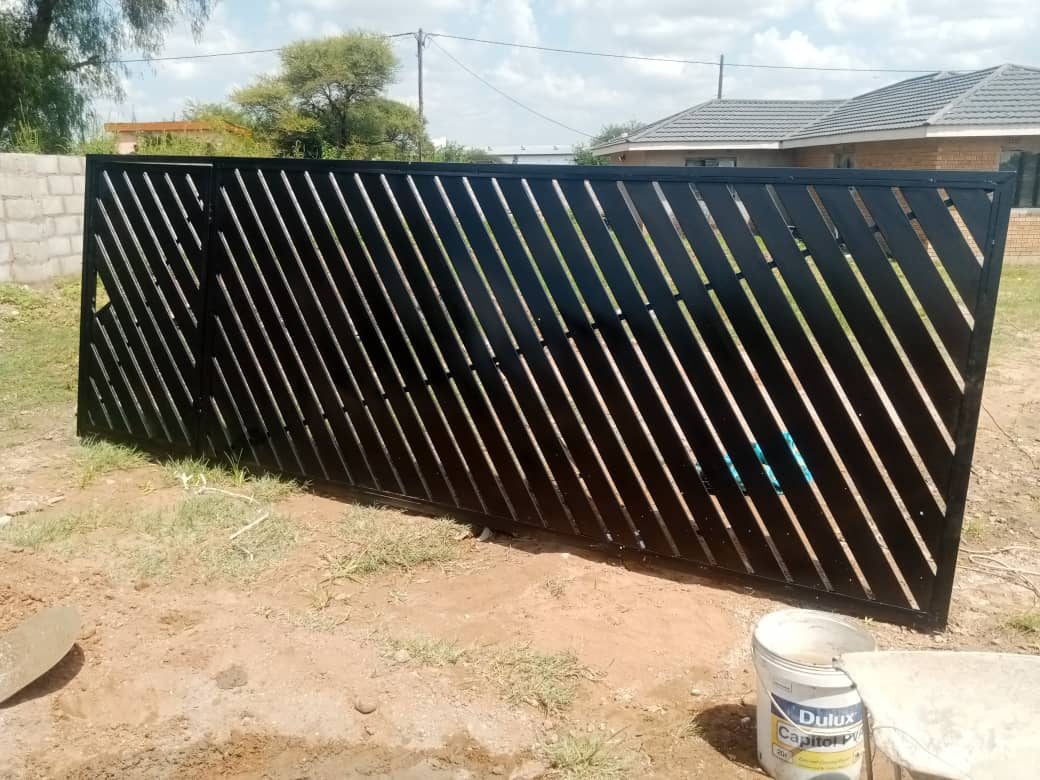 Black diagonal louver-style sliding gate ready for install — Tshipiworks