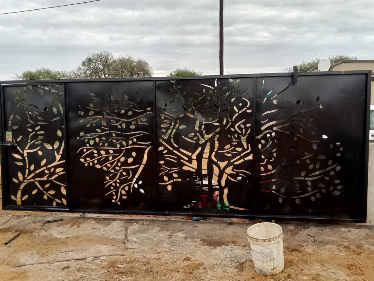 Laser-cut steel tree-of-life panel with savanna animal silhouettes — Tshipiworks Gabane