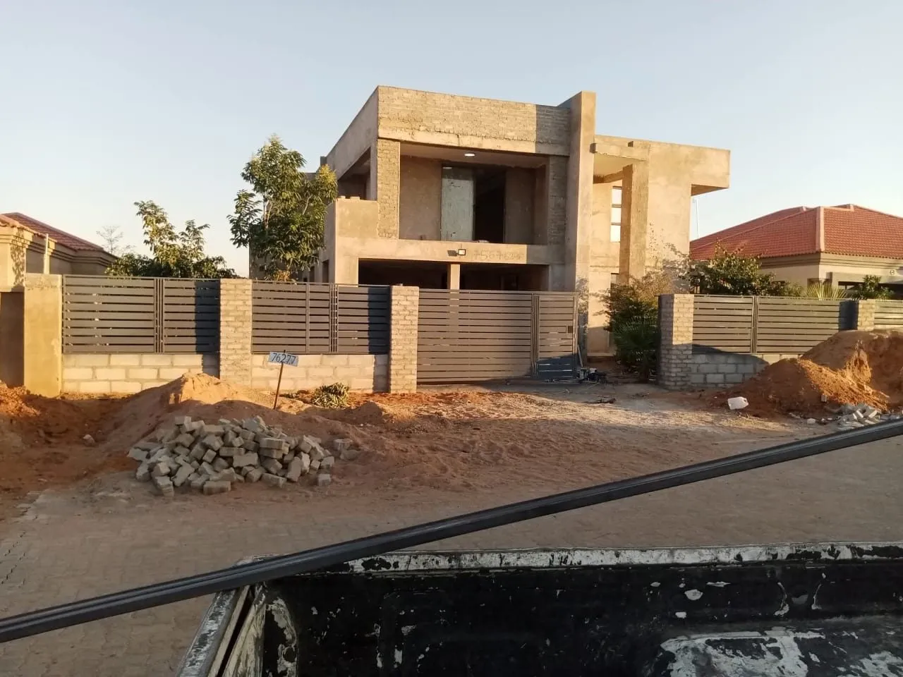 Matched steel sliding gate, fence and pedestrian gate at a home — Tshipiworks
