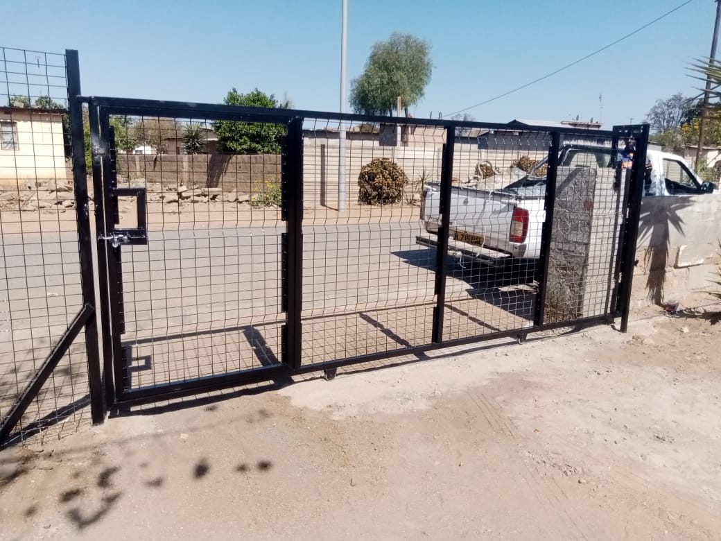 Black mesh pedestrian wicket gate with handle and lock box — Tshipiworks