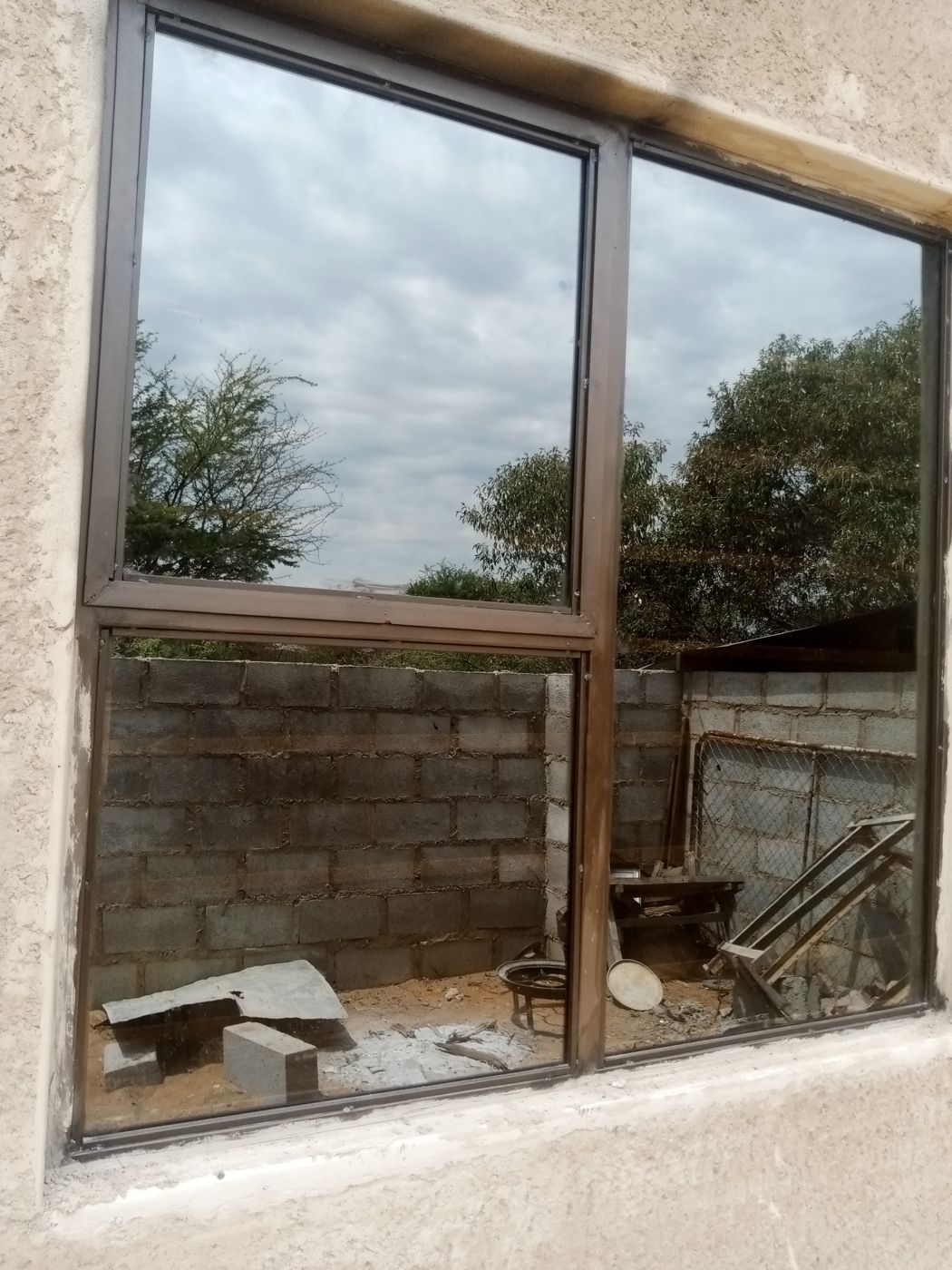 Tall four-pane brown steel window, Mochudi project