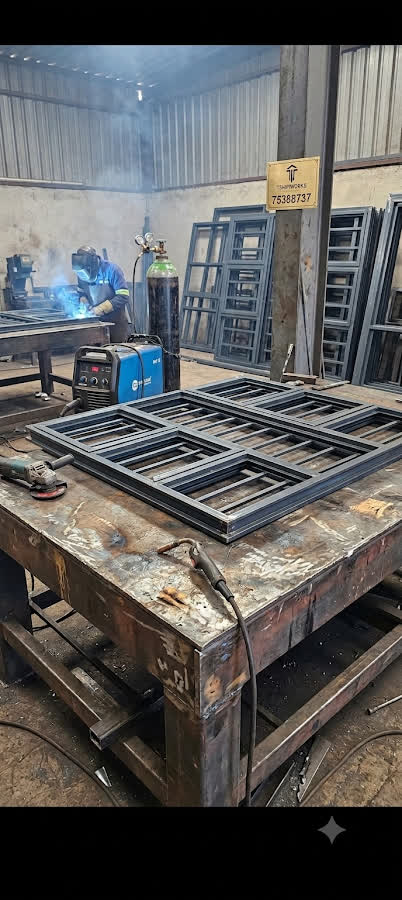 Steel gate frames on the welding table in the Tshipiworks Gabane workshop